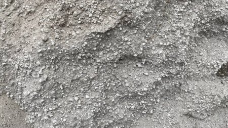 Texture of building bulk material spilling out in a large pile on the street