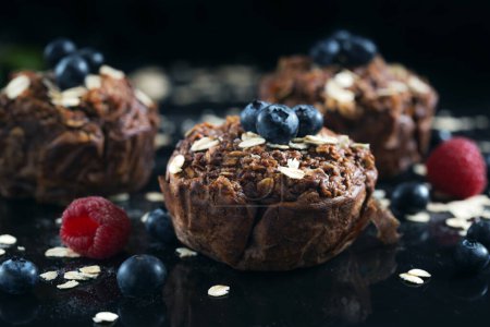 Chocolate muffins with raspberries, bluesberries and oat.