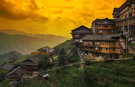Photo for Chinese village in the beautiful terraced rice fields in Longsheng. Tian Tou Zhai village in longji rice terrace in guangxi province of China. - Royalty Free Image