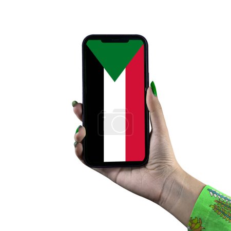 Téléchargez les photos : Le drapeau du Soudan est affiché sur un smartphone tenu par une jeune femme asiatique ou la main d'une femme. Isolé sur fond blanc. Patriotisme avec affichage moderne de technologie de téléphone portable. - en image libre de droit