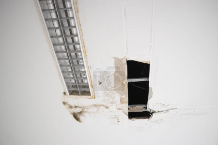 Photo for Gypsum moldy ceiling water leak decay hole interior office building - Royalty Free Image
