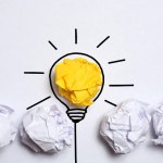 Creative thinking ideas and innovation concept. Paper scrap ball yellow colour with light bulb symbol