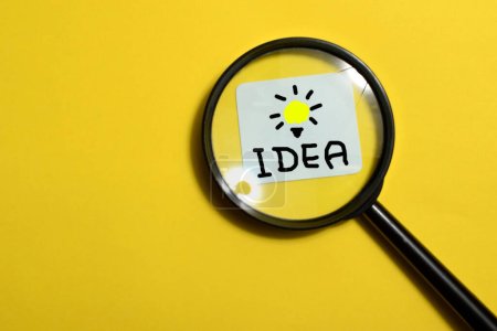 Photo for Soft focus, Creative idea concept, magnifying glass and light bulb icon with yellow background - Royalty Free Image