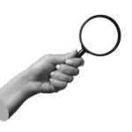 A female hand holding a magnifying glass isolated on a white background.  3d trendy 