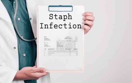 Photo for Doctor holding Paper Pad with Text Staph Infection - Royalty Free Image