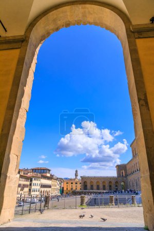 Photo for Glimpse of Palazzo Pitti on the Piazza de' Pitti square in the historic center of Florence, Italy. View of the main facade from arch of projecting wings. - Royalty Free Image