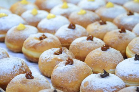 Photo for Fresh donuts with chocolate, jam at the bakery display for celebration. Sufganiyot - Israeli Donuts. Selective focus. Symbol of sweet Hanukkah donut - Sufganiyah. - Royalty Free Image