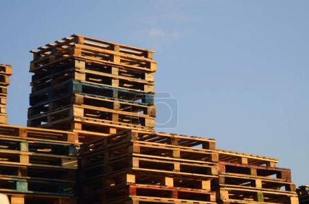 Photo for Wooden boxes and pallets. Many pallets stacked in stock, warehouse pallets, sky background - Royalty Free Image