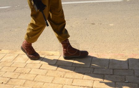 Photo for Israeli soldier without a face. Only boots. Soldier walking on asphalt. Soldiers IDF - Israel Defense Forces (Tzahal), IsraelI soldiers, Israeli army - Royalty Free Image