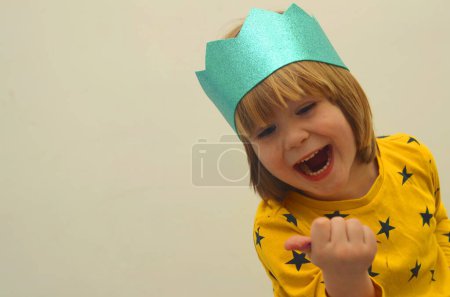 Photo for A little boy in a crown plays  Purim. Birthday, happy holidays. Isolate on white background, space for text - Royalty Free Image