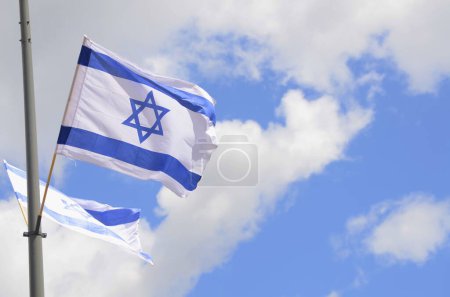 Photo for Flag of Israel against a bright blue sky. Star of David on a white background. - Royalty Free Image