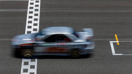 Photo for Race car blurred motion crossing the finish line on international circuit speed track, Motion blur Racing car crossing finish line on asphalt race track. - Royalty Free Image