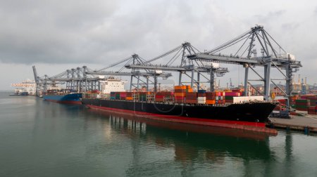 Navire porte-conteneurs de fret au port maritime terminal par temps orageux et nuages gris, Chargement et déchargement de navires porte-conteneurs import export conteneur logistique.