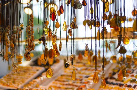 Photo for Necklaces and other amber souvenirs. Amber of different colors and sizes. Exposition of stones of amber for tourists, souvenir. - Royalty Free Image