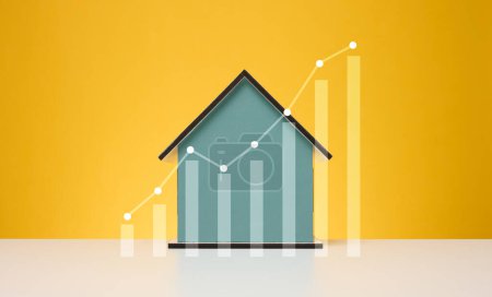 Foto de Casa de madera y un gráfico con indicadores de crecimiento. Aumento de los precios inmobiliarios, aumento de las facturas de servicios públicos - Imagen libre de derechos