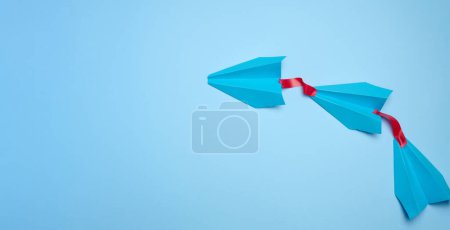 Photo for A group of blue airplanes follows each other, a concept of mass influence and manipulation, Top view, copy space - Royalty Free Image