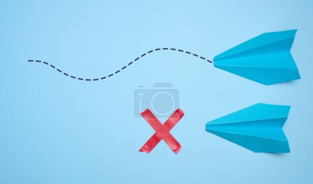 Photo for Two paper boats, the path to one of them is stopped. The concept of rejection, obstacles - Royalty Free Image