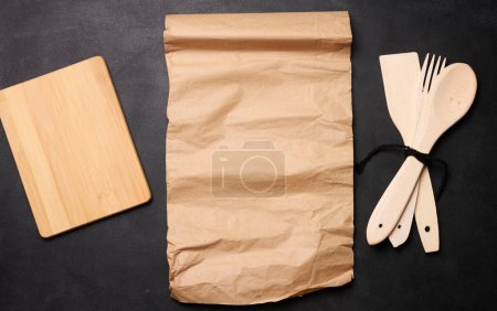 Photo for Wooden spoon, fork and brown sheet of paper - Royalty Free Image