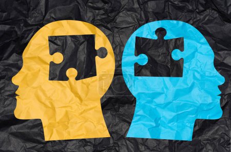 Photo for Two silhouettes of heads cut out from crumpled paper with puzzle pieces. Concept of similarity among people, finding a match - Royalty Free Image