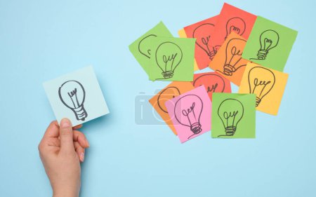 Drawn electric lamps on stickers, concept of searching for new ideas, brainstorming