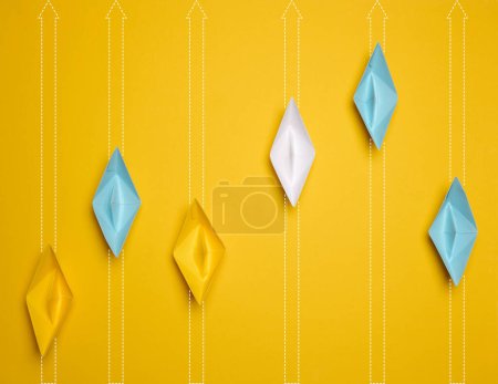 Photo for Paper boats move forward at different distances, strong leader concept, top view - Royalty Free Image