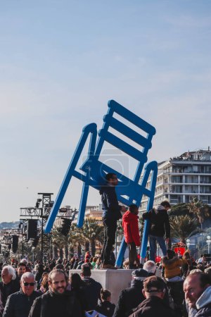 Photo for Nice, France - 19.02.2023 : People watching the parade during the Carnival of Nice 2023, on the Promenade des Anglais - Royalty Free Image