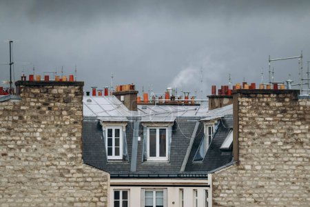 Photo for Close-up of Parisian rooftops and mansards with chimneys - Royalty Free Image