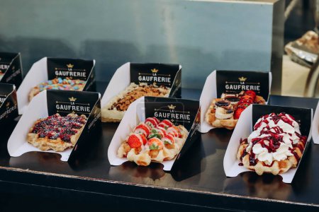 Photo for Brussels, Belgium - October 21, 2023: Traditional Belgian waffles with different toppings - Royalty Free Image