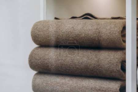 Close-up of brown cashmere sweaters folded in a stack