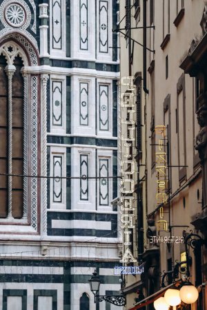 Florence, Italy - 29 December, 2023: Signboards in Florence with the Cathedral of Santa Maria del Fiore in the background