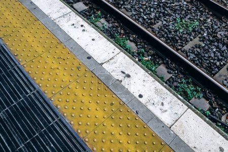 Edge of the platform and yellow line at the train station