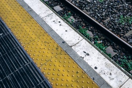 Edge of the platform and yellow line at the train station