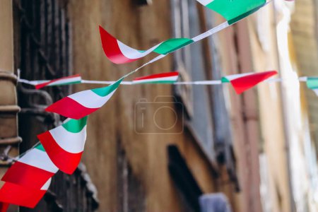 ondeando banderas italianas en la calle del casco antiguo