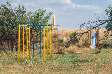 Photo for Countryside. An empty playground damaged by shelling. War in Ukraine. Russian invasion of Ukraine. Destruction of infrastructure. Terror of civilians. War crimes - Royalty Free Image
