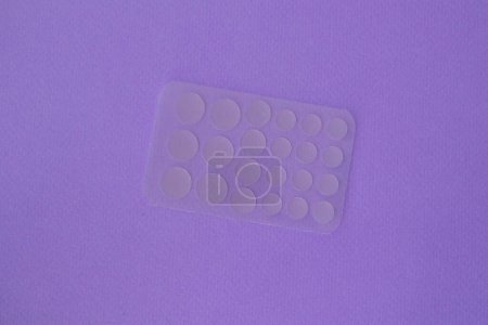 Photo for Transparent acne patches on purple. - Royalty Free Image