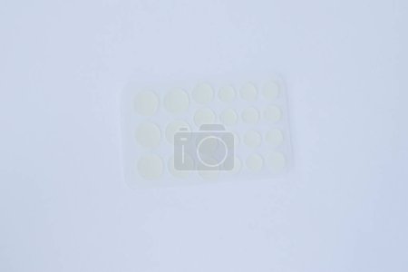 Photo for Transparent pimple patches on a white surface. Top view - Royalty Free Image