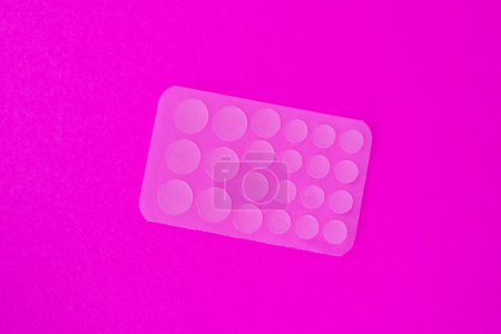 Photo for Transparent acne patches on pink background - Royalty Free Image