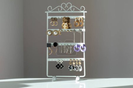 Photo for Lots of modern women's earrings on a stand - Royalty Free Image