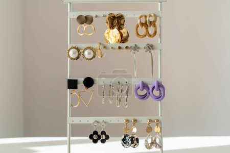 Photo for Lots of modern women's earrings on a stand. Beautiful women earrings. - Royalty Free Image