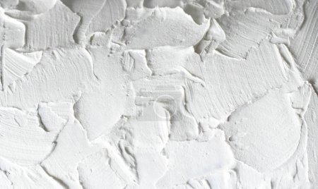 Téléchargez les photos : Macro photo of a white rough wall. Close-up of the putty. - en image libre de droit