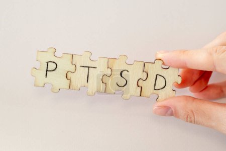 Photo for Hand Writing PTSD on wooden puzzles. Post traumatic stress disorder - Royalty Free Image