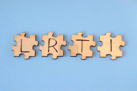 Photo for Lower Respiratory Tract Infections - LRTI. Lettering on wooden puzzles on a blue background. - Royalty Free Image