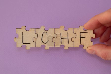 Photo for Written word abbreviation lchf Low Carb High Fat on wooden puzzles - Royalty Free Image