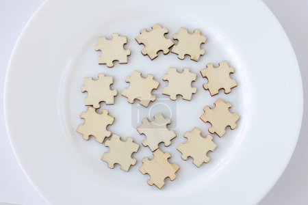 Photo for Mock up of 13 wooden puzzles on a plate. Thirteen blank spaces for inscription. The concept of healthy eating. - Royalty Free Image