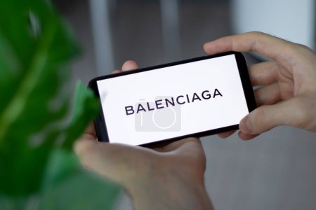 Photo for IRPEN, UKRAINE - JANUARY 20 20223, Closeup of smartphone screen Balenciaga logo lettering with in mans hands, Illustrative Editorial - Royalty Free Image