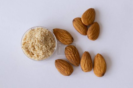 Gluten-free almond nut flour on white background. Top view, close-up.