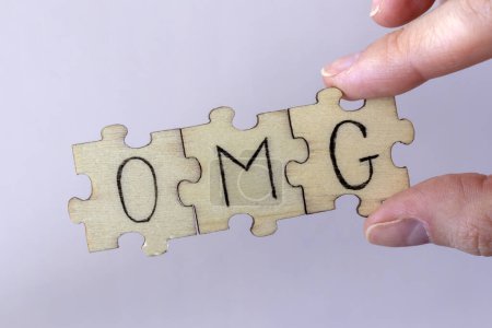 Photo for The acronym OMG, which stands for Oh My God. The letters written on the puzzles - Royalty Free Image