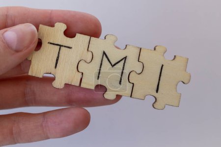 Photo for The acronym TMI, which stands for Too Much Information. The letters written on the puzzles - Royalty Free Image