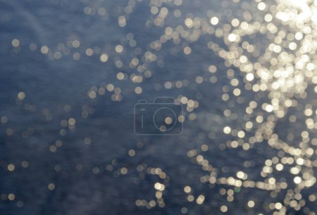 Sun rays on ice. Blurred natural swirl pattern texture, background photo.