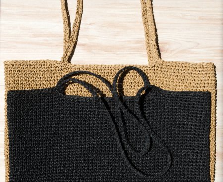 Two women's bags made of raffia black and beige. Crocheted beach bags, handmade.